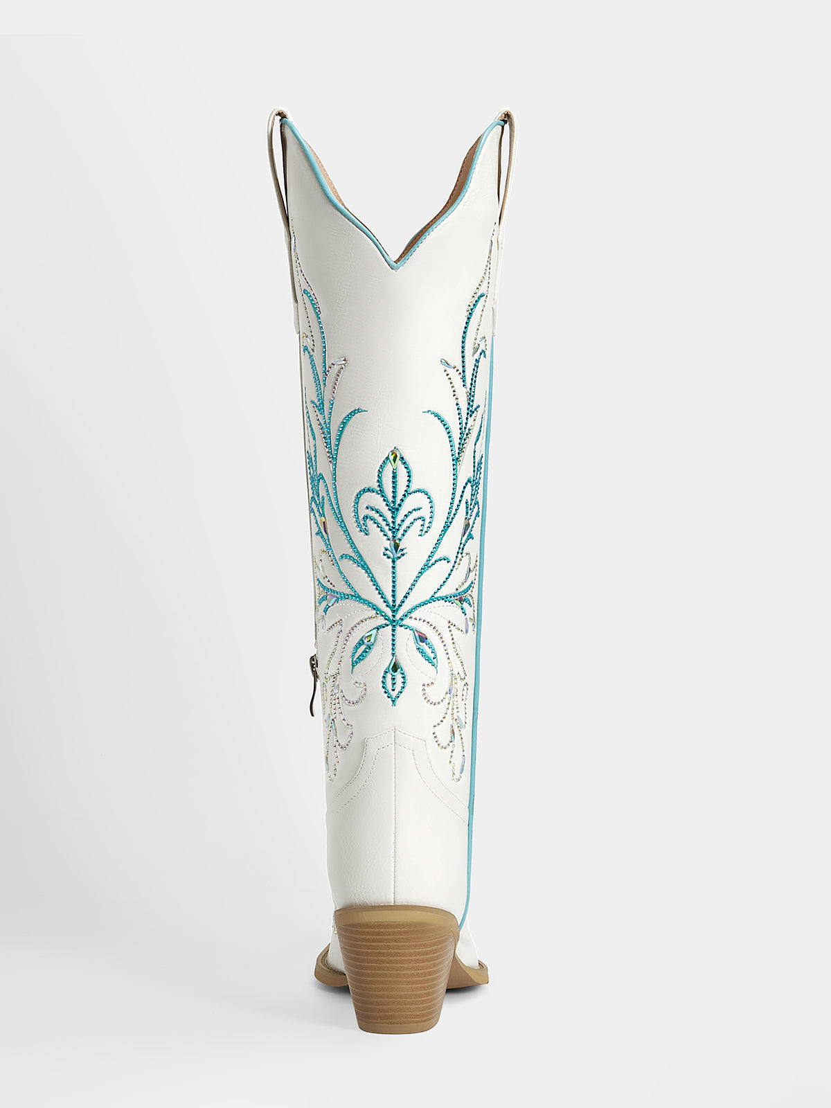 A single white cowboy boot shown from the back, featuring turquoise and silver embroidered floral patterns on the shaft and a tan stacked heel, set against a light gray studio background.