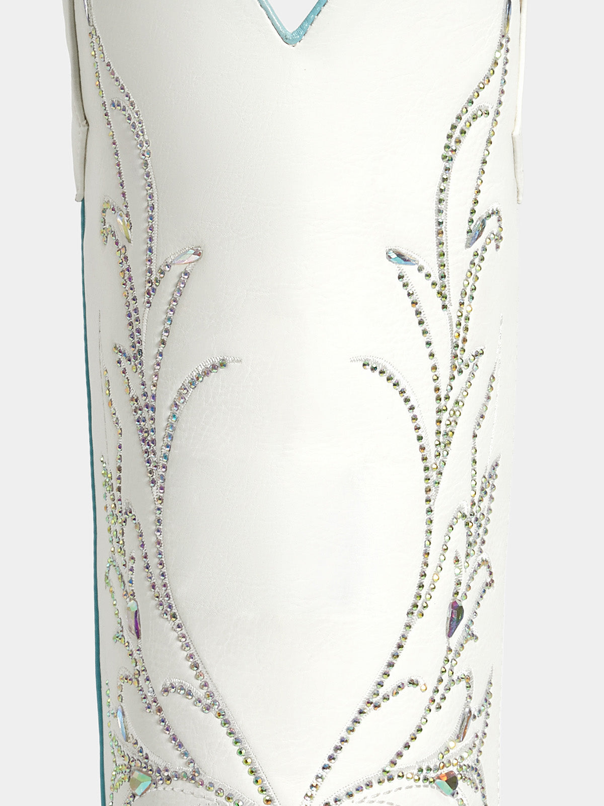 Close-up of a white western-style boot or boot shaft decorated with intricate silver rhinestone embroidery and small iridescent accents.