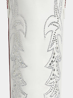 Close-up of a white western boot featuring intricate silver rhinestone embroidery on the shaft.