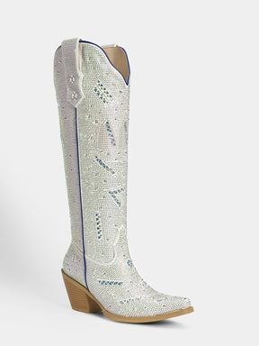 A single knee-high western boot covered in silver rhinestones with blue accents and a tan block heel, shown against a light gray background.