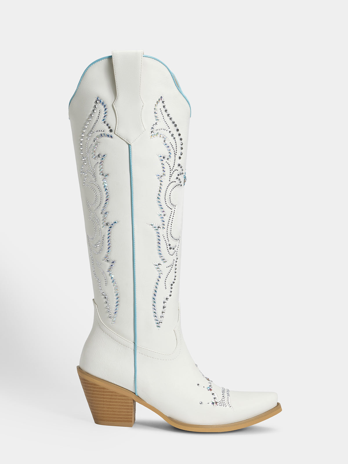 A white leather cowboy boot with silver western embroidery, a light blue piping accent, and a brown stacked block heel, shown against a light gray background.